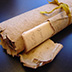 Tightly rolled bound manuscript.