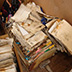 Flood-damaged files on the floor of a storage shed.