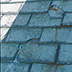 Old roofing materials (in this case, slate) can fail, exposing the lower layer(s) to the elements.