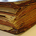 A bound volume of large maps with multiple folds, used heavily by a sea captain, displays both water and handling damage.