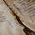 Detail of parchment leaves damaged by water.