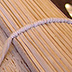 Detail of raised cords using the sewn-through-the-fold method of leaf attachment. The cords, typically made of linen, are then used to attach the boards.