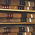 Stack large, heavy books no more than two or three high to make them easy and safe to retrieve. Unfortunately, these books are shelved on unsealed wood.