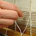 Sewing a text block is often accomplished by grouping several folios together, one inside another, to form sections. The sections are then sewn to each other with thread. Shown here: sewing on raised cords using a sewing frame.