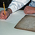 Written and photographic documentation of the condition of an object is recorded by a conservator prior to beginning treatment.
